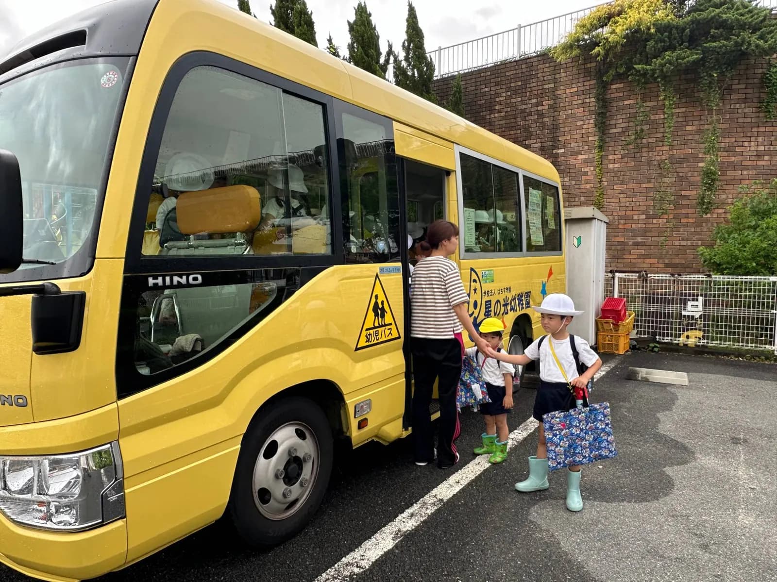 星の光幼稚園の園バスに乗り込む親子